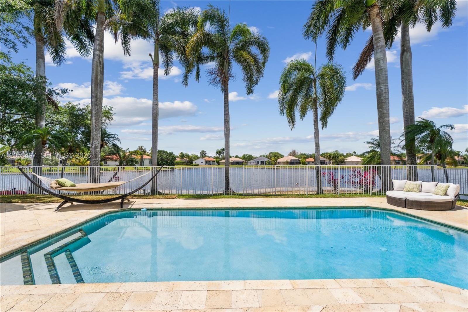 Pool and lake framed by royal palms