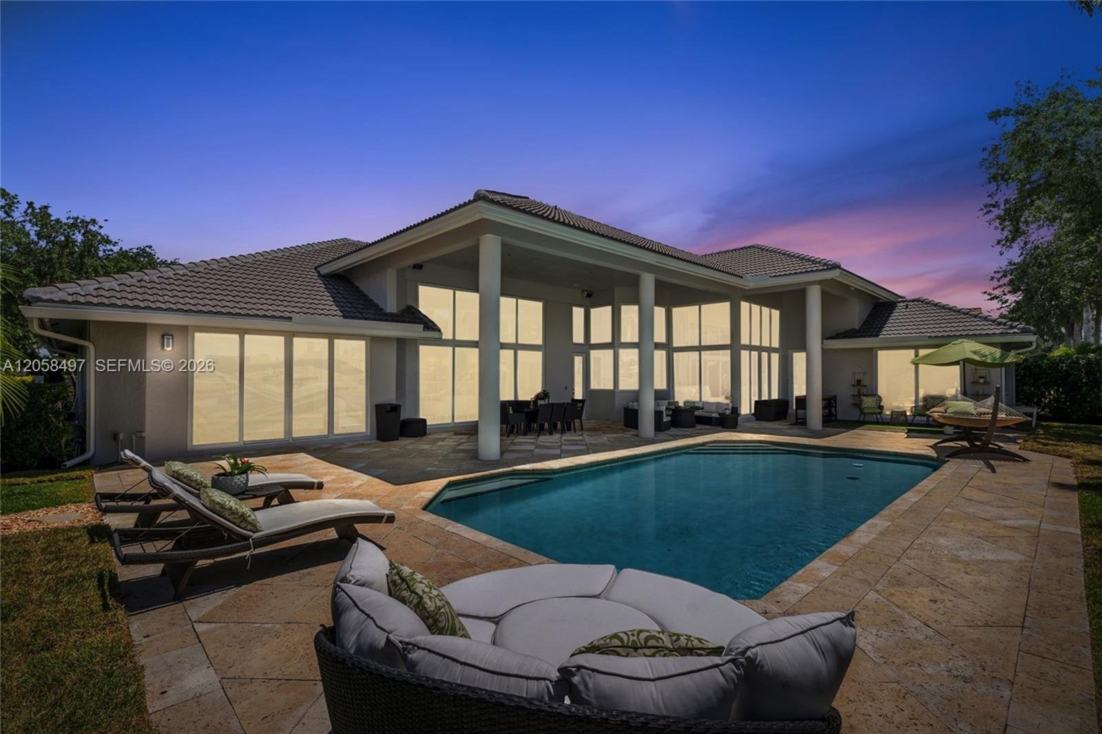 Twilight view of the pool and loggia